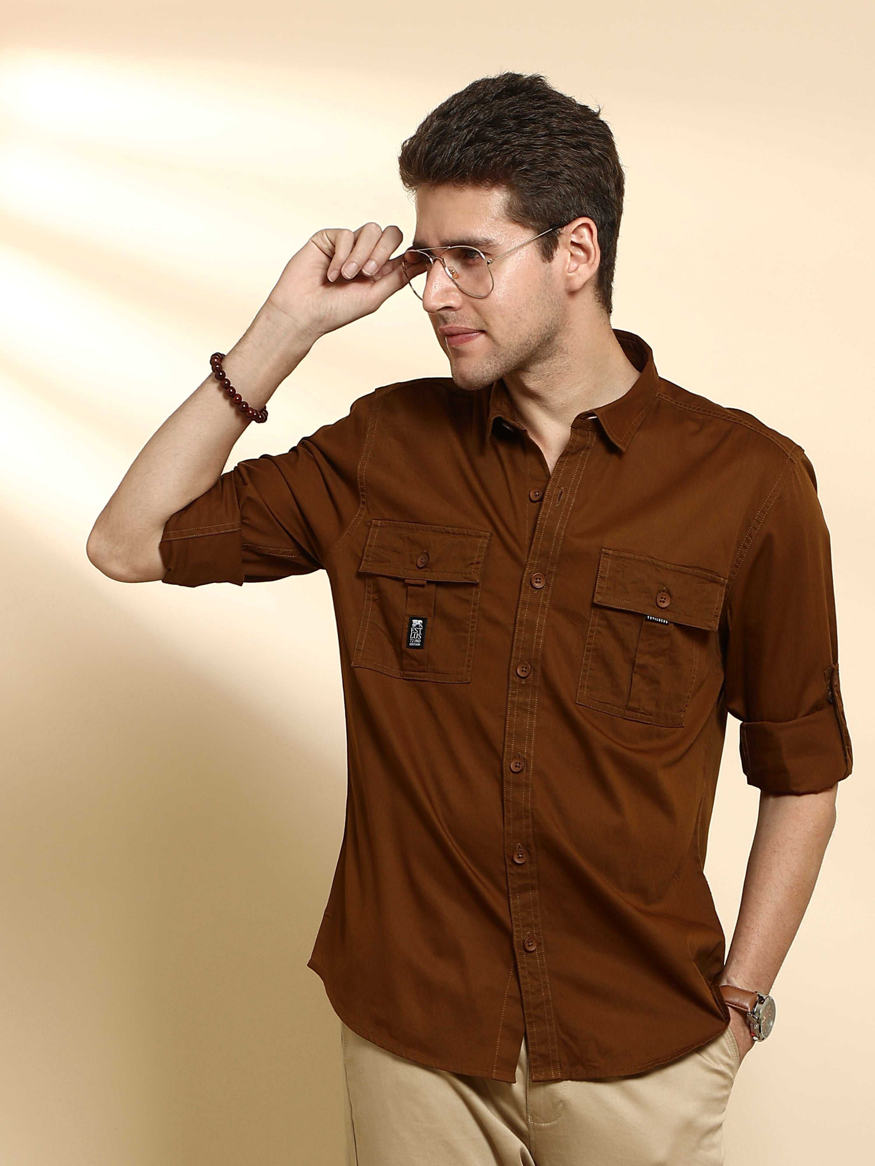 Bronze brown Cargo casual full sleeve shirt shop online at Estilocus. • 100% PREMIUM COTTON • Full-sleeve solid shirt• Cut and sew placket• Regular collar• Double button round cuffs.• Double pocket with flap• Curved hemline• Finest quality sewing with all