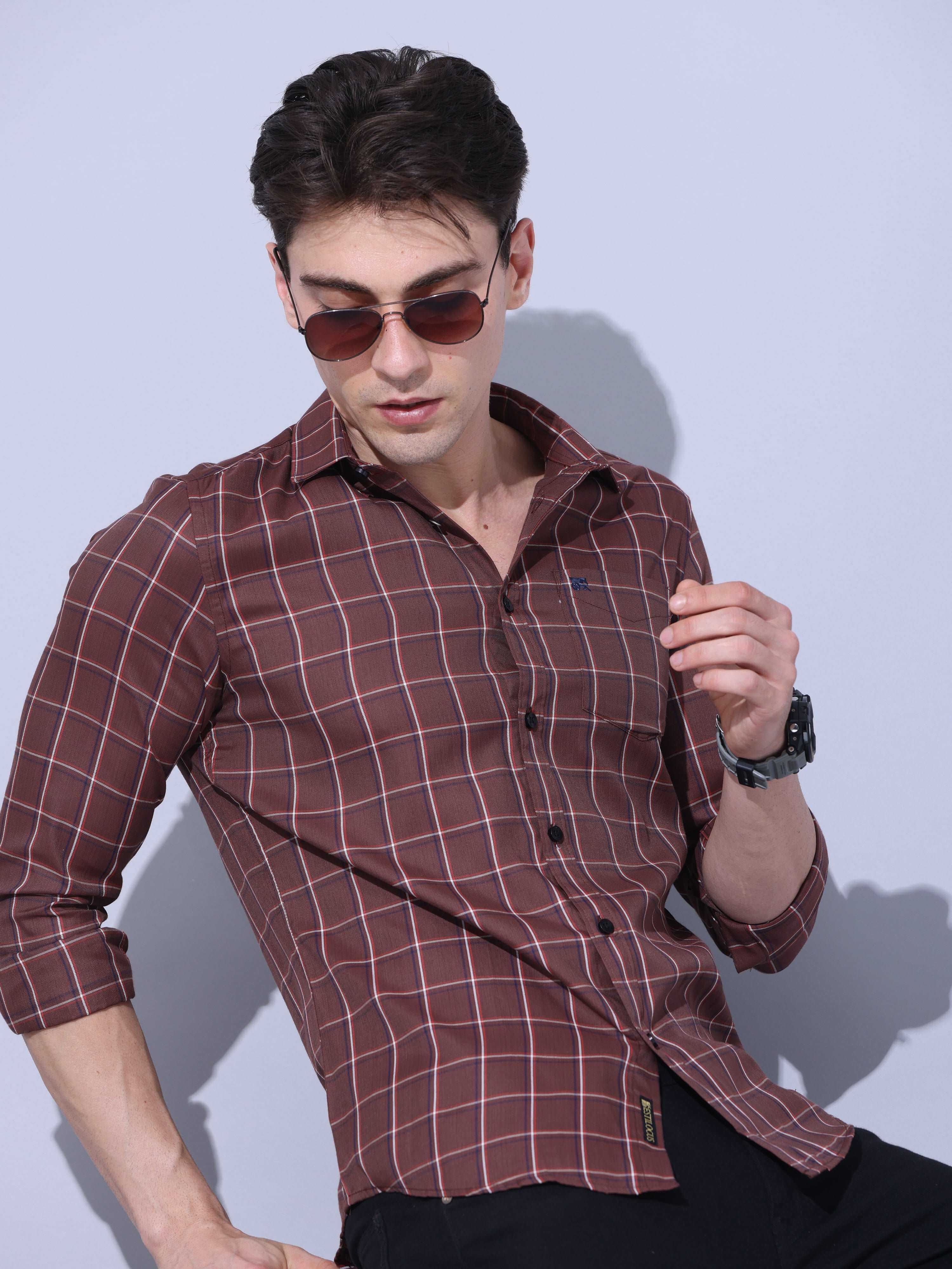 Brown Check Casual Shirt shop online at Estilocus. • Full-sleeve brown colured check shirt with regular collar• Cut and sew placket • Double button square cuff. • Single pocket with logo embroidery • Curved hemline • Finest quality sewing • Machine wash c