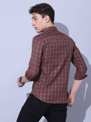 Brown Check Casual Shirt shop online at Estilocus. • Full-sleeve brown colured check shirt with regular collar• Cut and sew placket • Double button square cuff. • Single pocket with logo embroidery • Curved hemline • Finest quality sewing • Machine wash c