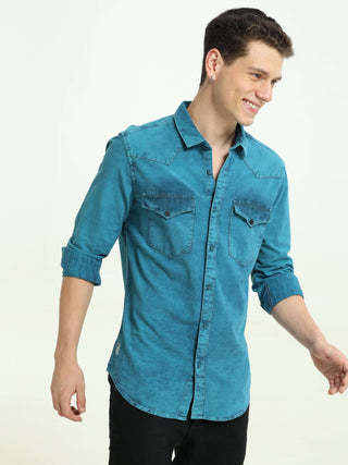 Denim Indigo-Teal over-dyed casual shirt shop online at Estilocus. • 100% premium Denim• Full-sleeve solid shirt• Cut and sew placket• Regular collar• Double button round cuff's.• Single pocket • Cut and sew front panel with high-quality print• Curved hem