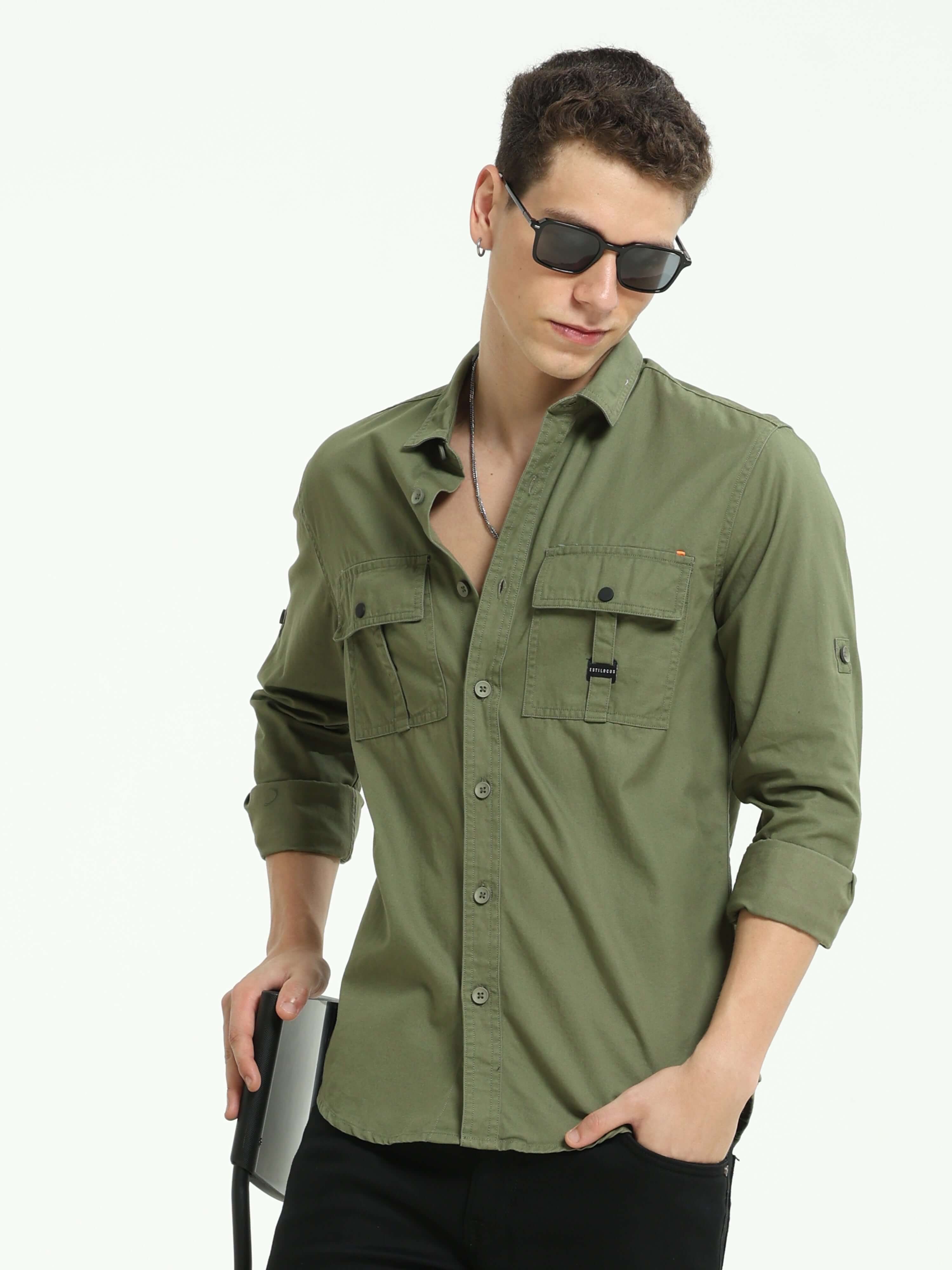 Moss green Solid double pocket shirt shop online at Estilocus. 100% Cotton • Full-sleeve solid shirt• Cut and sew placket• Regular collar• Double button edge cuff • Double pocket with flap • Curved bottom hemline• Finest printing at front placket. • All d