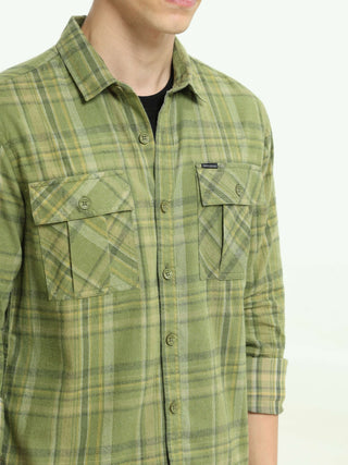 Olive green Check double pocket shirt shop online at Estilocus. 100% Cotton • Full-sleeve check shirt• Cut and sew placket• Regular collar• Double button edge cuff• Double pocket with flap• Curved bottom hemline .• All double needle construction, finest q