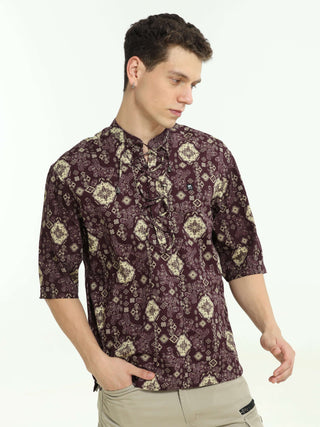 Oversized wine colour printed kurta shop online at Estilocus. • Five-sleeve stripe printed kurta• Mandarin collar• Single button square cuff.• Single pocket with logo embroidery• Curved hemline• All Single-needle construction, finest quality sewing• Machi