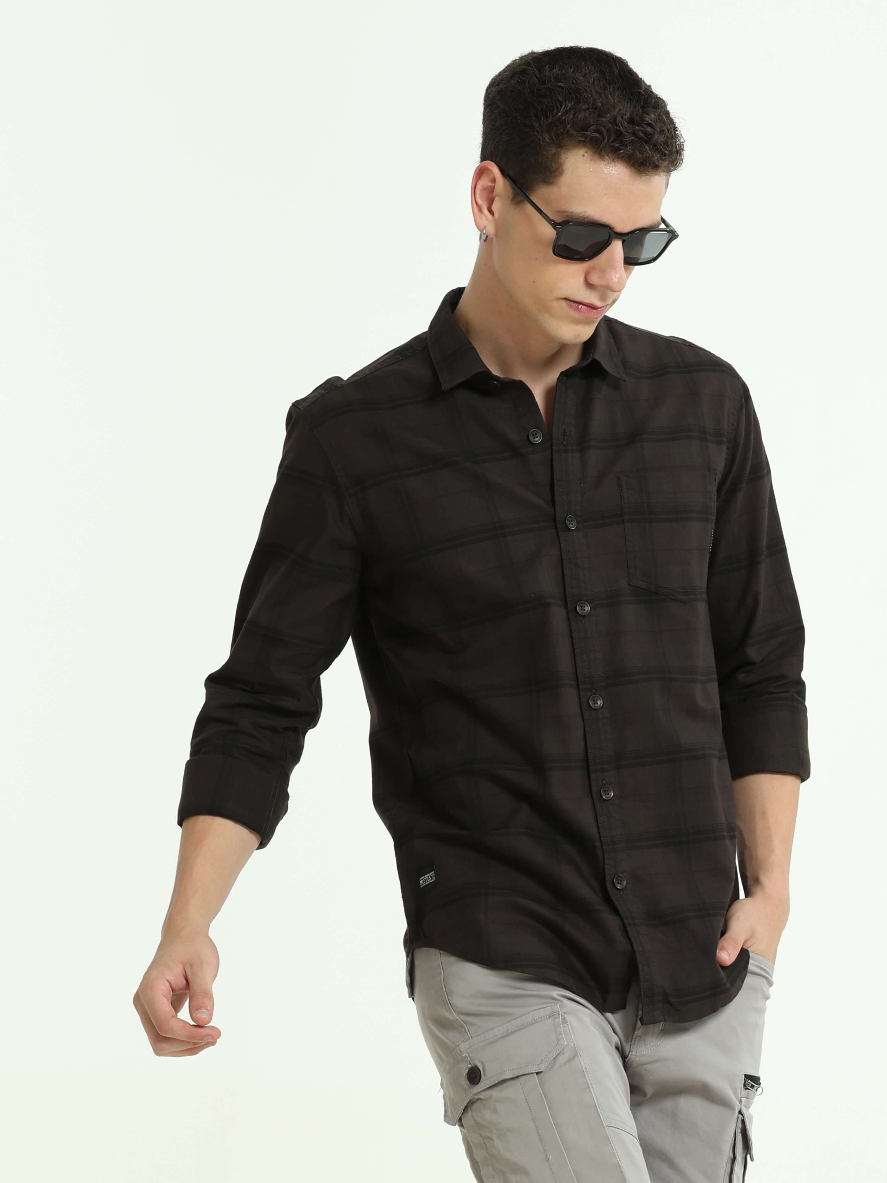 Sage brown casual check shirt shop online at Estilocus. 100% Cotton • Full-sleeve check shirt• self fold placket • Regular collar• Double button edge cuff • pocketless • Curved bottom hemline• Finest quality brand embroidery at front placket. • All sinlge