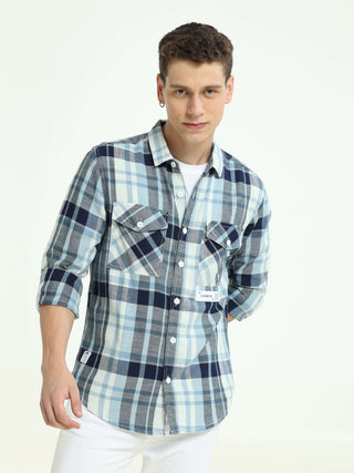 Indigo check double pocket shirt shop online at Estilocus. 100% Cotton • Full-sleeve check shirt• Cut and sew placket• Regular collar• Double button edge cuff• Double pocket with flap• Curved bottom hemline .• All double needle construction, finest qualit