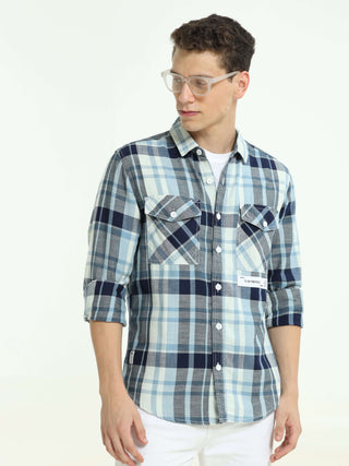 Indigo check double pocket shirt shop online at Estilocus. 100% Cotton • Full-sleeve check shirt• Cut and sew placket• Regular collar• Double button edge cuff• Double pocket with flap• Curved bottom hemline .• All double needle construction, finest qualit