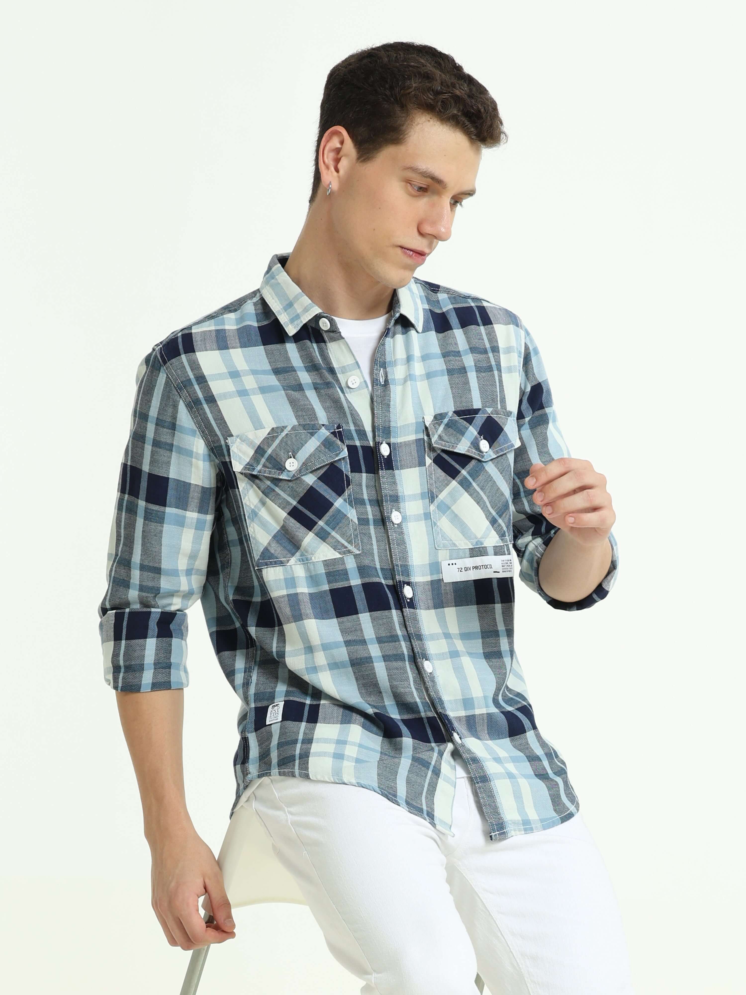 Indigo check double pocket shirt shop online at Estilocus. 100% Cotton • Full-sleeve check shirt• Cut and sew placket• Regular collar• Double button edge cuff• Double pocket with flap• Curved bottom hemline .• All double needle construction, finest qualit