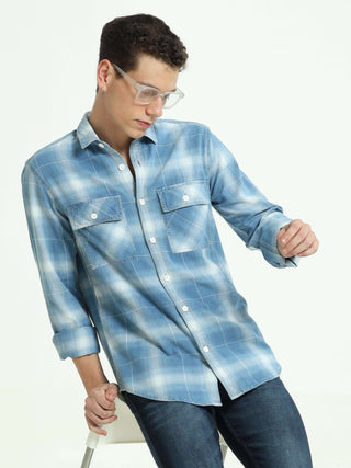 Indigo colored check double pocket shirt shop online at Estilocus. 100% Cotton • Full-sleeve check shirt• Cut and sew placket• Regular collar• Double button edge cuff • Double pocket with flap • Curved bottom hemline . • All double needle construction, fi