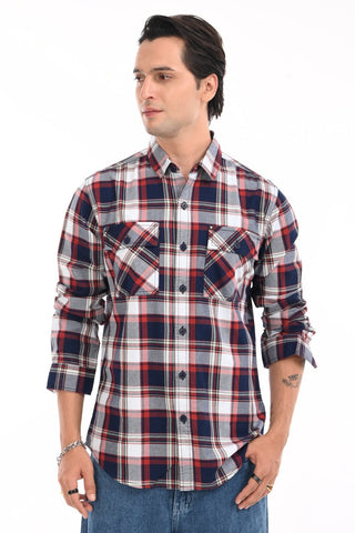 Man wearing a plaid shirt on a white background.