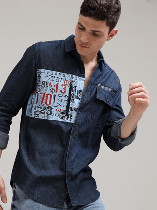 Navy Denim Double Pocket Shirt shop online at Estilocus. Denim ,Full-sleeve shirt Cut and sew placket. Regular collar Double button edge cuff Zipper hidden pocket, other end with flap pocket Curved bottom hemline HD elegant print at pocket All Double need