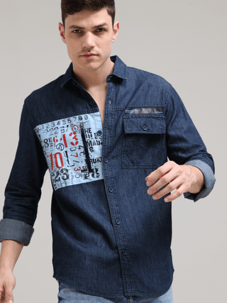 Navy Denim Double Pocket Shirt shop online at Estilocus. Denim ,Full-sleeve shirt Cut and sew placket. Regular collar Double button edge cuff Zipper hidden pocket, other end with flap pocket Curved bottom hemline HD elegant print at pocket All Double need