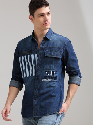 Denim Navy Double Pocket Shirt shop online at Estilocus. Denim ,Full-sleeve shirt Cut and sew placket. Regular collar Double button edge cuff Zipper hidden pocket, other end with flap pocket Curved bottom hemline HD elegant print at pocket All Double need