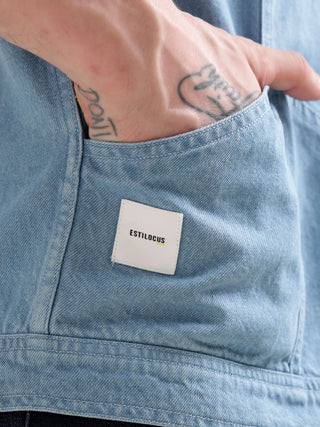 Light blue denim jacket with a visible brand label on the right side  pocket.