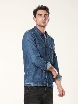 Man wearing a blue denim jacket on a white background.