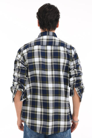 Person wearing a plaid shirt with rolled-up sleeves on a white background.