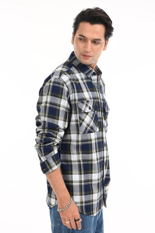 Man wearing a plaid shirt on a white background.