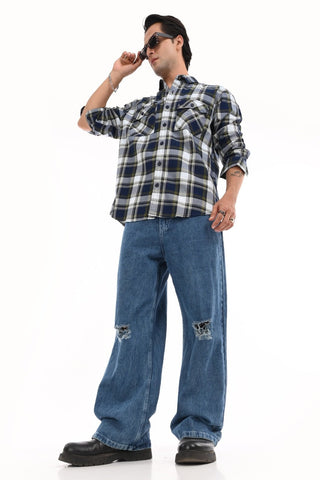 Person wearing a plaid shirt and jeans on a white background.