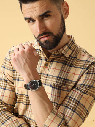 Man wearing a plaid shirt and watch on a beige background
