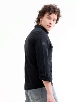 Man wearing a black denim and showing right side of his arm  on a white background.