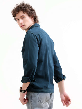 Person wearing a blue shirt on a white background.