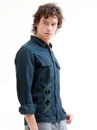 Man wearing a dark blue denim jacket with lace-up front design on a white background.