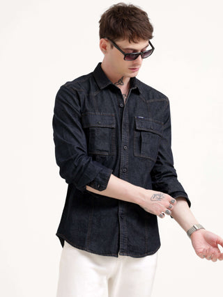 Man wearing a black denim shirt and sunglasses on a white background