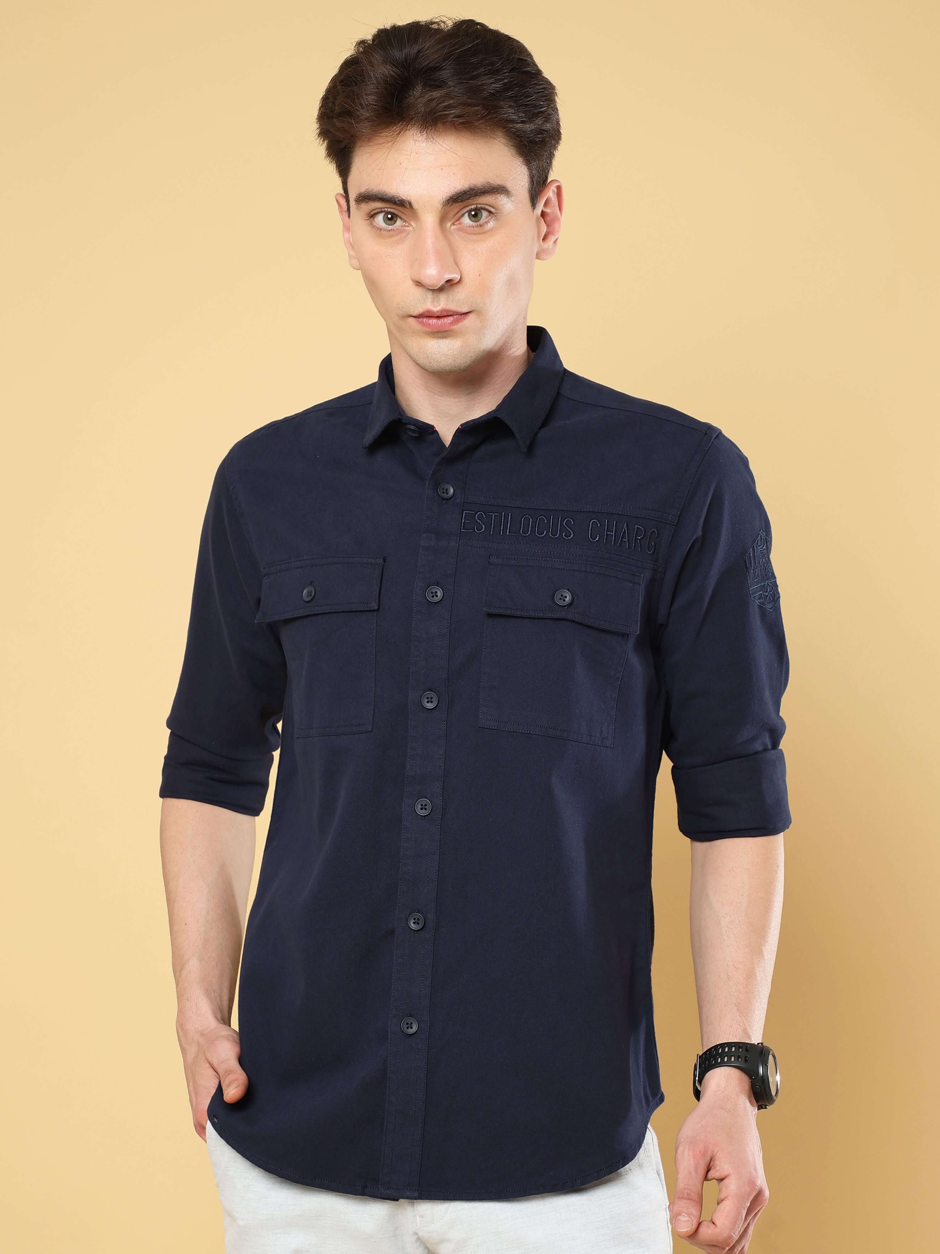 Navy Twill Solid Cargo Shirt shop online at Estilocus. • 100% premium cotton• Full-sleeve solid shirt• Cut and sew placket• Regular collar• Double button round cuff's.• Double pocket with flap.• Finest embroidery on sleeve and front panel• Curved hemline•