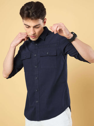 Navy Twill Solid Cargo Shirt shop online at Estilocus. • 100% premium cotton• Full-sleeve solid shirt• Cut and sew placket• Regular collar• Double button round cuff's.• Double pocket with flap.• Finest embroidery on sleeve and front panel• Curved hemline•