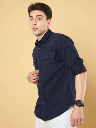 Navy Twill Solid Cargo Shirt shop online at Estilocus. • 100% premium cotton• Full-sleeve solid shirt• Cut and sew placket• Regular collar• Double button round cuff's.• Double pocket with flap.• Finest embroidery on sleeve and front panel• Curved hemline•