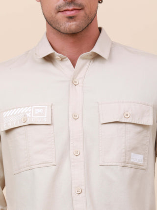 Beige Solid Double Pocket Full-Sleeve Shirt shop online at Estilocus. 100% Cotton , Full-sleeve solid shirt Cut and sew placket Regular collar Double button edge cuff Double pocket with flap Curved bottom hemline Finest printing at pocket . All double nee