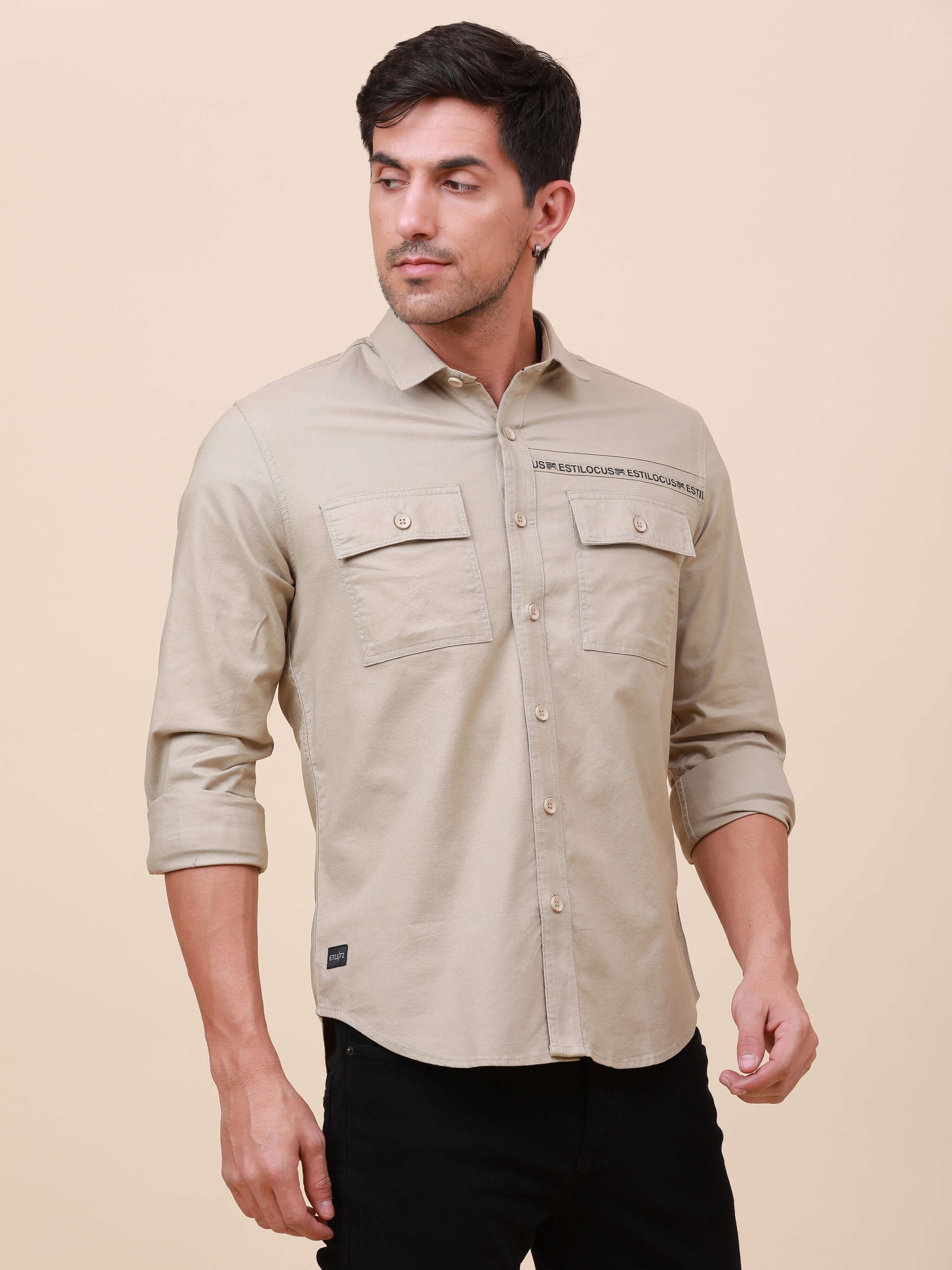 Beige Solid Double Pocket Shirt shop online at Estilocus. 100% Cotton , Full-sleeve solid shirt Cut and sew placket Regular collar Double button edge cuff Double pocket with flap Curved bottom hemline Finest printing at front placket. All double needle co