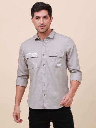 Grey Solid Double Pocket Shirt shop online at Estilocus. 100% Cotton , Full-sleeve solid shirt Cut and sew placket Regular collar Double button edge cuff Double pocket with flap Curved bottom hemline Finest printing at pocket . All double needle construct