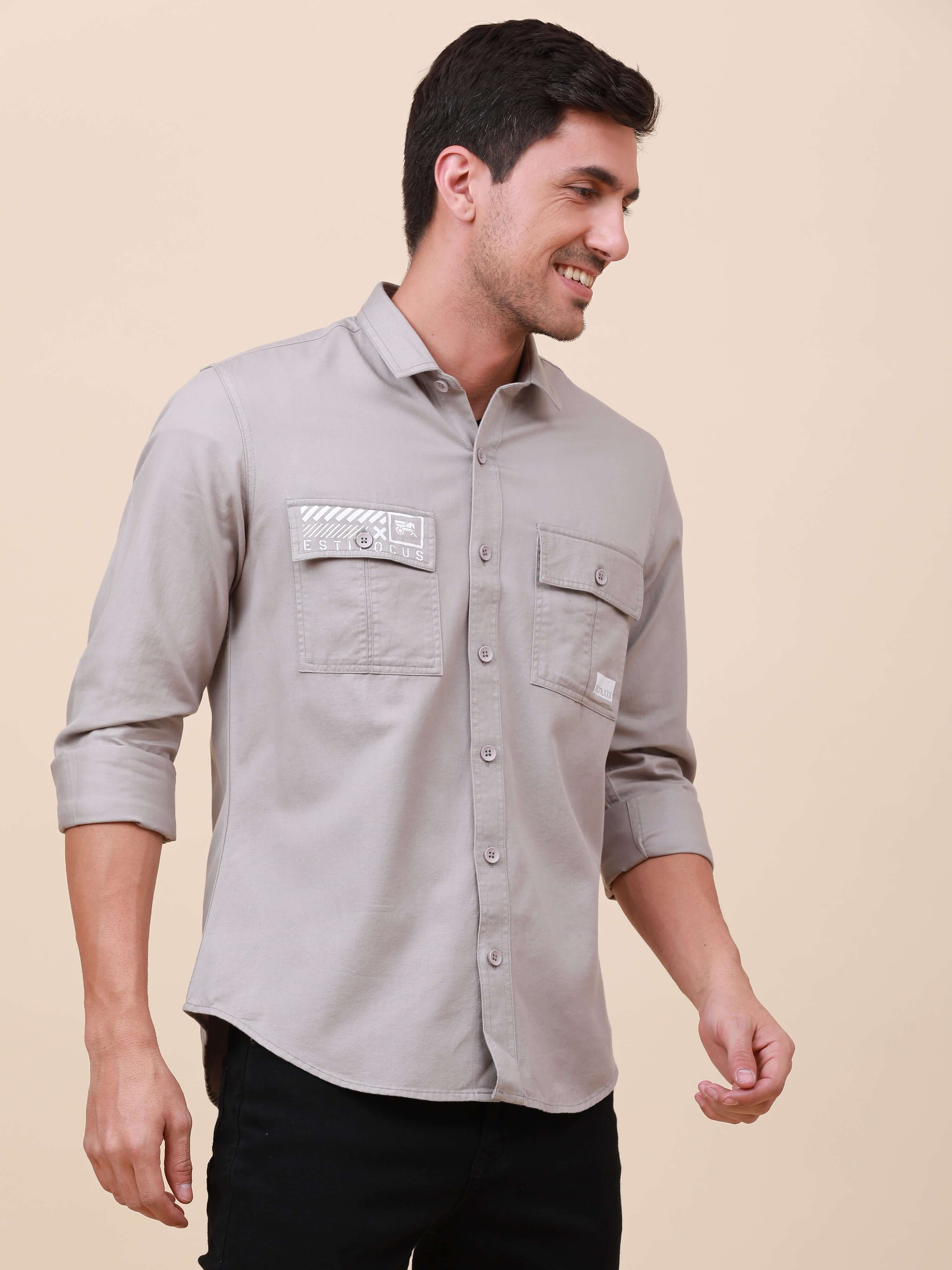 Grey Solid Double Pocket Shirt shop online at Estilocus. 100% Cotton , Full-sleeve solid shirt Cut and sew placket Regular collar Double button edge cuff Double pocket with flap Curved bottom hemline Finest printing at pocket . All double needle construct