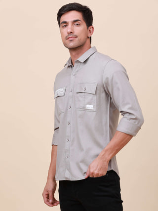 Grey Solid Double Pocket Shirt shop online at Estilocus. 100% Cotton , Full-sleeve solid shirt Cut and sew placket Regular collar Double button edge cuff Double pocket with flap Curved bottom hemline Finest printing at pocket . All double needle construct