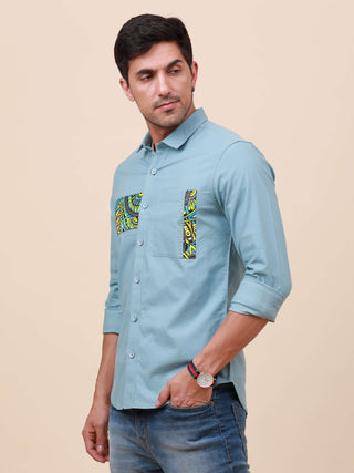 Pale Teal Solid Single Pocket Shirt shop online at Estilocus. 100% Cotton ,Full-sleeve solid shirt Cut and sew placket Regular collar Double button edge cuff Single pocket Curved bottom hemline HD elegant printing at front placket and pocket. All double n