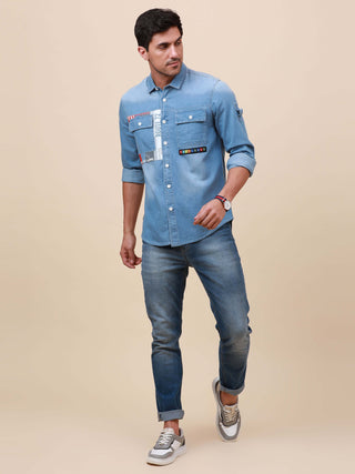 Blue Denim Double Pocket Shirt shop online at Estilocus. Denim ,Full-sleeve shirt cut and sew placket. Regular collar Double button edge cuff Double pocket with flap Curved bottom hemline HD elegant print @ panel All Double needle construction, finest qua