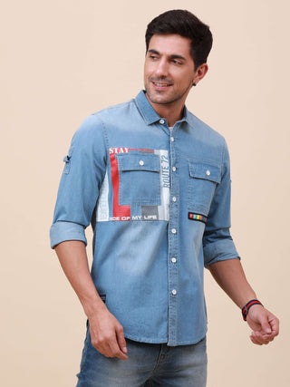 Blue Denim Double Pocket Shirt shop online at Estilocus. Denim ,Full-sleeve shirt cut and sew placket. Regular collar Double button edge cuff Double pocket with flap Curved bottom hemline HD elegant print @ panel All Double needle construction, finest qua