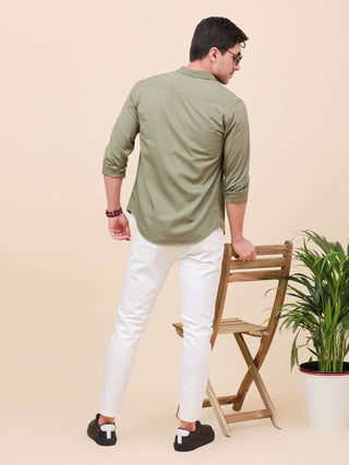 Olive Green Solid Single Pocket Shirt shop online at Estilocus. 100% Cotton ,Full-sleeve solid shirt Cut and sew placket Regular collar Double button edge cuff Single pocket Curved bottom hemline Finest printing at front placket. All double needle constru