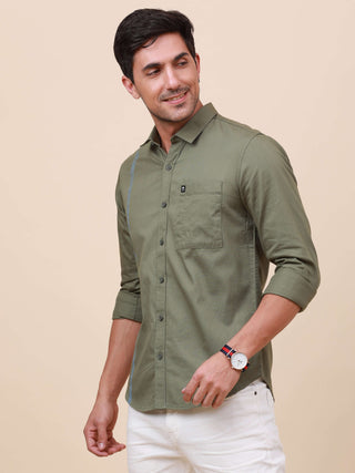 Olive Green Solid Single Pocket Shirt shop online at Estilocus. 100% Cotton ,Full-sleeve solid shirt Cut and sew placket Regular collar Double button edge cuff Single pocket Curved bottom hemline Finest printing at front placket. All double needle constru