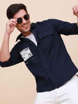 Dark Navy Solid Double Pocket Shirt shop online at Estilocus. 100% Cotton , Full-sleeve solid shirt Cut and sew placket Regular collar Double button edge cuff Double pocket with flap Curved bottom hemline Finest printing at pocket . All double needle cons