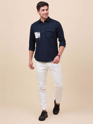 Dark Navy Solid Double Pocket Shirt shop online at Estilocus. 100% Cotton , Full-sleeve solid shirt Cut and sew placket Regular collar Double button edge cuff Double pocket with flap Curved bottom hemline Finest printing at pocket . All double needle cons