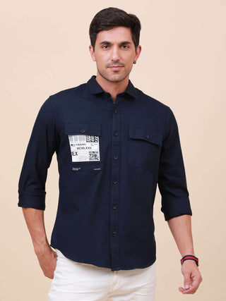 Dark Navy Solid Double Pocket Shirt shop online at Estilocus. 100% Cotton , Full-sleeve solid shirt Cut and sew placket Regular collar Double button edge cuff Double pocket with flap Curved bottom hemline Finest printing at pocket . All double needle cons