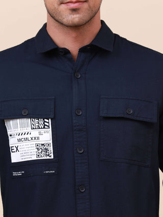 Dark Navy Solid Double Pocket Shirt shop online at Estilocus. 100% Cotton , Full-sleeve solid shirt Cut and sew placket Regular collar Double button edge cuff Double pocket with flap Curved bottom hemline Finest printing at pocket . All double needle cons