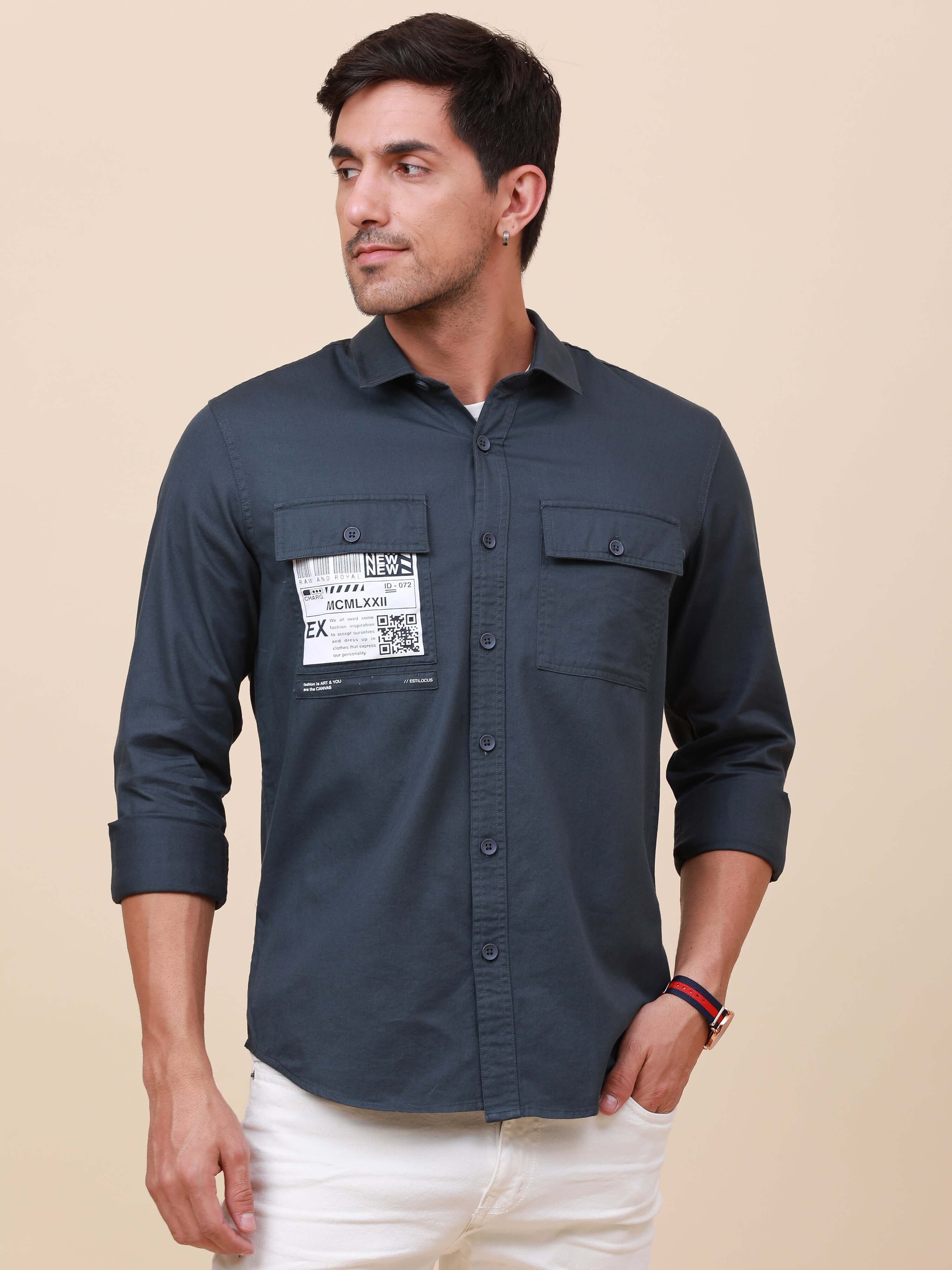 Navy Solid Double Pocket Shirt shop online at Estilocus. 100% Cotton ,Full-sleeve solid shirt Cut and sew placket Regular collar Double button edge cuff Double pocket Curved bottom hemline Finest printing at front placket. All double needle construction,