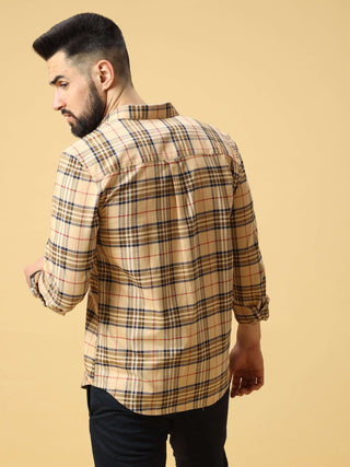 Back view of a man wearing a beige checkered shirt, standing against a light studio background.