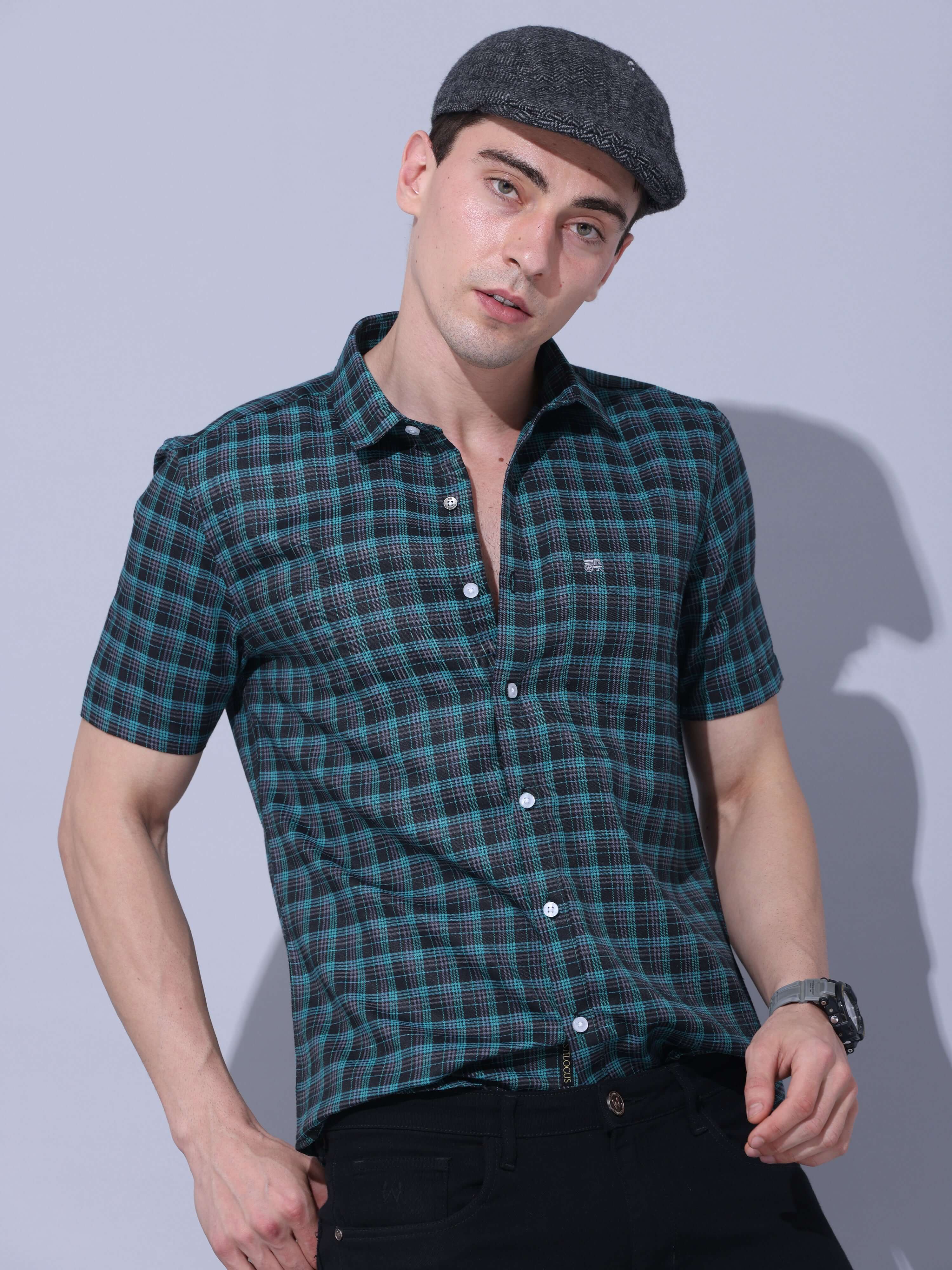 Green Check Casual Shirt shop online at Estilocus. The meticulous detailing of the check pattern adds a touch of refinement, creating a visual masterpiece that transcends simplicity.This regular collar,comfort fit,half sleeve, green checkered shirt can be