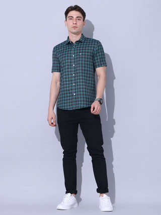 Green Check Casual Shirt shop online at Estilocus. The meticulous detailing of the check pattern adds a touch of refinement, creating a visual masterpiece that transcends simplicity.This regular collar,comfort fit,half sleeve, green checkered shirt can be