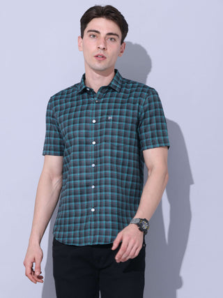 Green Check Casual Shirt shop online at Estilocus. The meticulous detailing of the check pattern adds a touch of refinement, creating a visual masterpiece that transcends simplicity.This regular collar,comfort fit,half sleeve, green checkered shirt can be