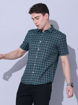 Green Check Casual Shirt shop online at Estilocus. The meticulous detailing of the check pattern adds a touch of refinement, creating a visual masterpiece that transcends simplicity.This regular collar,comfort fit,half sleeve, green checkered shirt can be