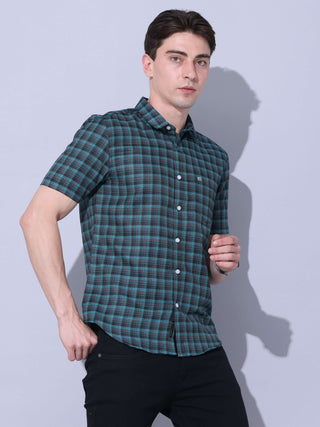 Green Check Casual Shirt shop online at Estilocus. The meticulous detailing of the check pattern adds a touch of refinement, creating a visual masterpiece that transcends simplicity.This regular collar,comfort fit,half sleeve, green checkered shirt can be